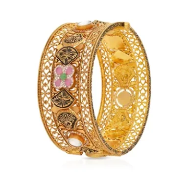 Intricate gold bangle with floral design and filigree detailing.