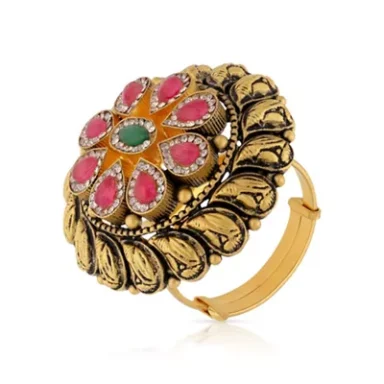 Gold decorative bangle with a floral motif, featuring pink and green gemstones.