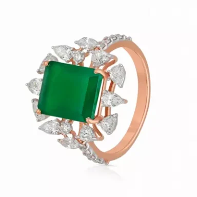 Emerald ring set in rose gold with diamond accents.