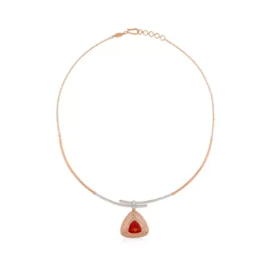 Rose gold necklace featuring a triangular pendant with a red gemstone.