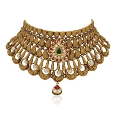 Gold ornamental necklace with intricate design and gemstone embellishments.