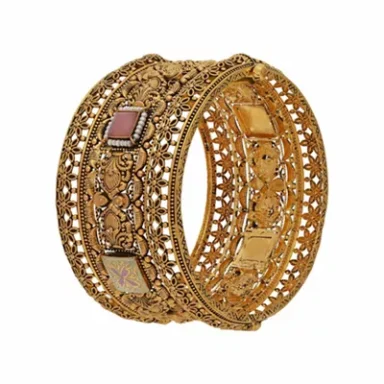 Intricate gold bangle with ornate detailing and decorative stones.