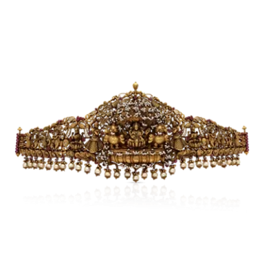 Ornate gold crown with intricate detailing and hanging pearls.