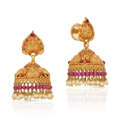 Gold jhumka earrings with intricate design and red gemstone accents.