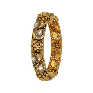 Gold bangle with intricate patterns and embellishments, featuring pearls and gemstones.