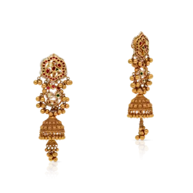 Golden traditional earrings with intricate designs and red embellishments.