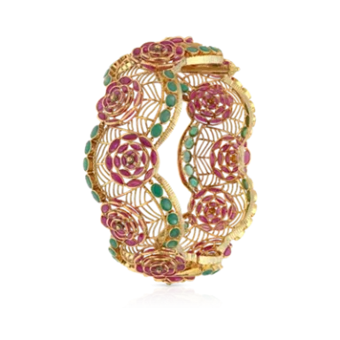 Gold bangle featuring intricate floral patterns with ruby and emerald stones.