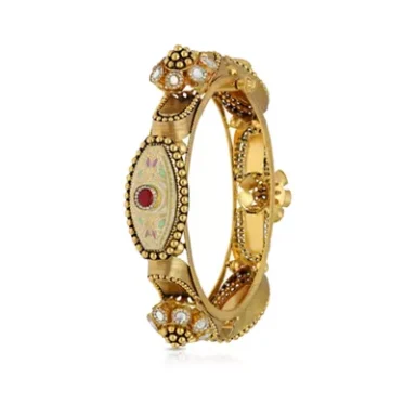 A gold bangle bracelet adorned with pearls and a decorative watch face.