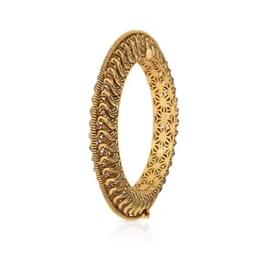 Gold hoop earring with intricate patterned detailing.