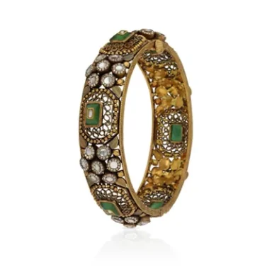 Gold bangle adorned with green stones and pearls, featuring intricate designs.