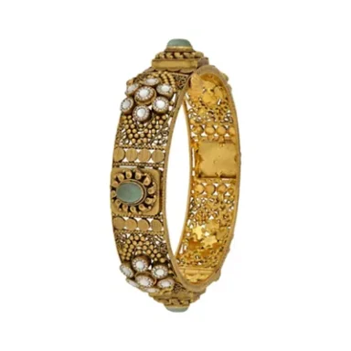 Gold bangle adorned with pearls and intricate floral designs.
