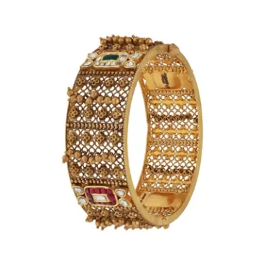 Intricate golden bangle adorned with colourful gemstones and detailed patterns.