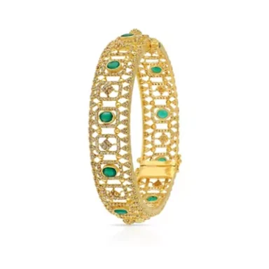 Gold bangle with intricate lattice design and emerald green stones.