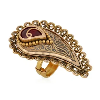  decorative gold ring with a red stone and intricate floral design.