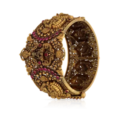 Ornate gold bracelet with intricate designs and colourful embellishments.