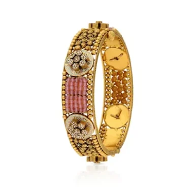 Elegant gold bangle adorned with pink and clear stones.